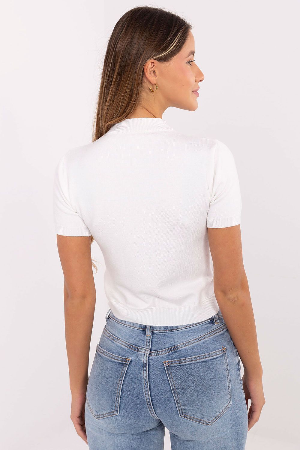 Back of beige-white sweater showing fine knit texture.