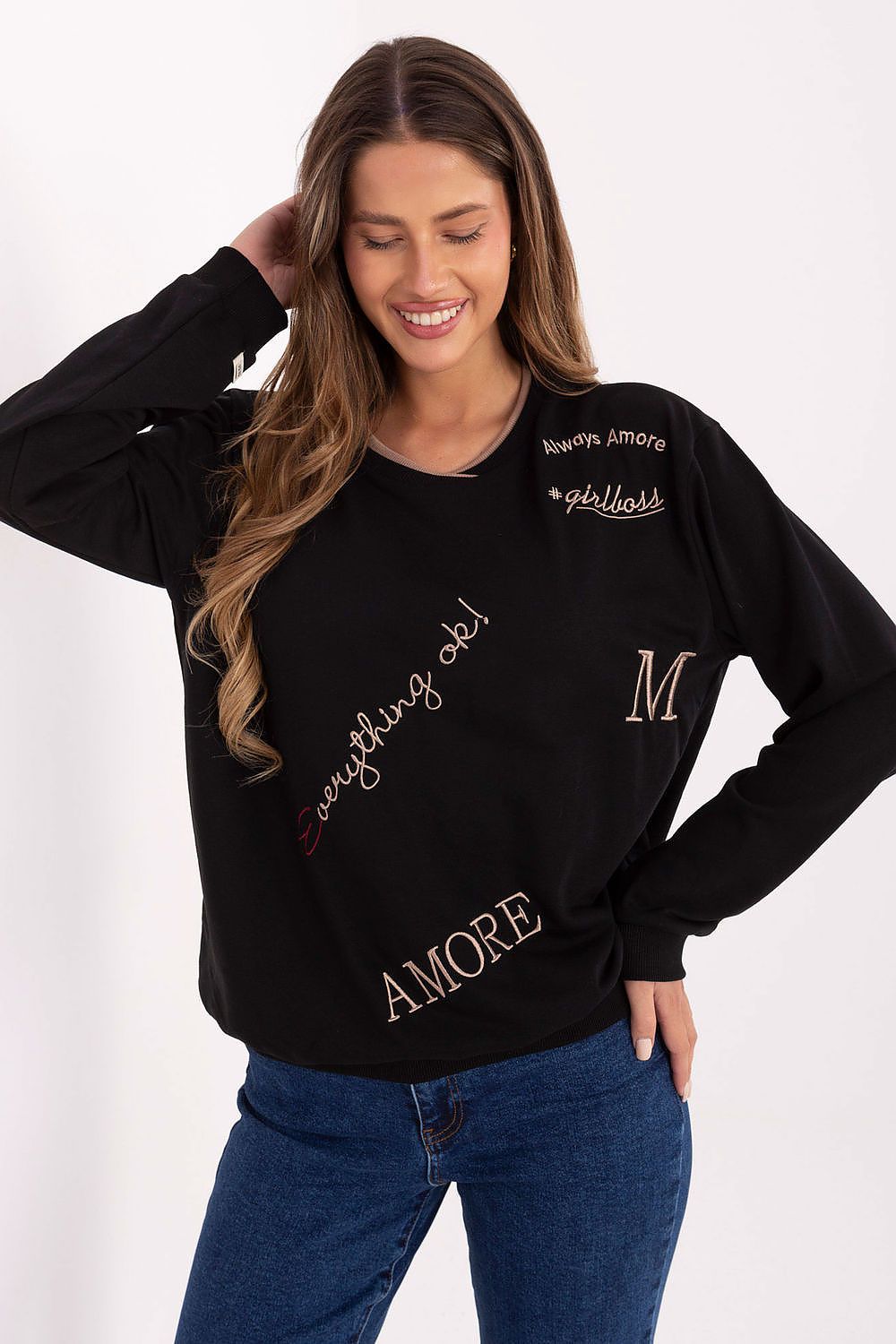 Woman wearing a black sweatshirt with text and a logo on a white background