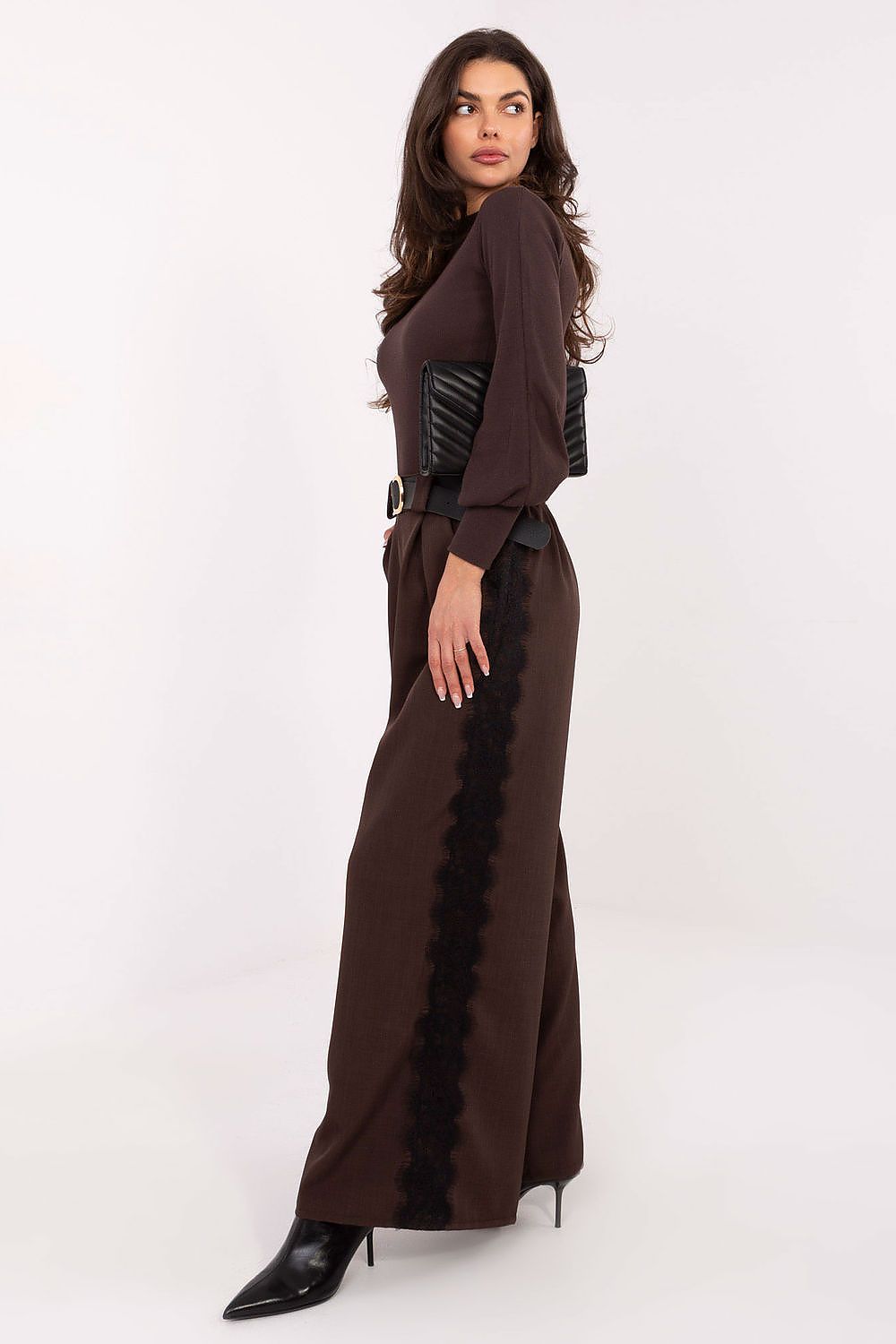 Close-up side view of ribbed fabric texture and soft turtleneck collar detail.