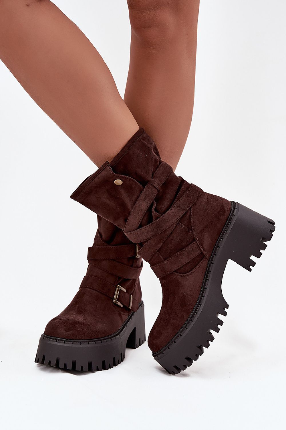 Brown platform boots with buckle detail on a white background