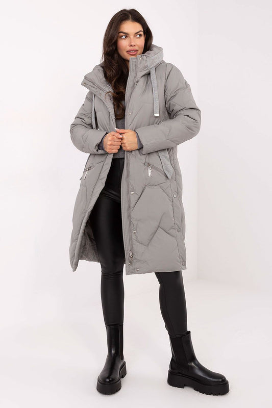 Woman wearing a gray parka coat on a white background