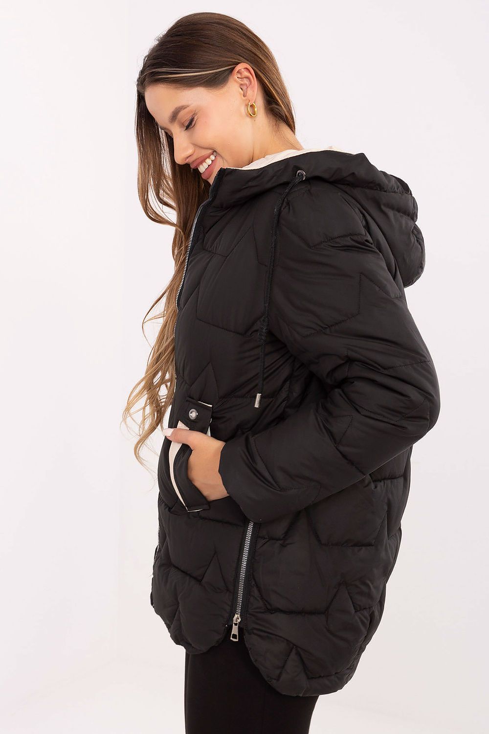 Woman wearing a black puffer jacket on a white background
