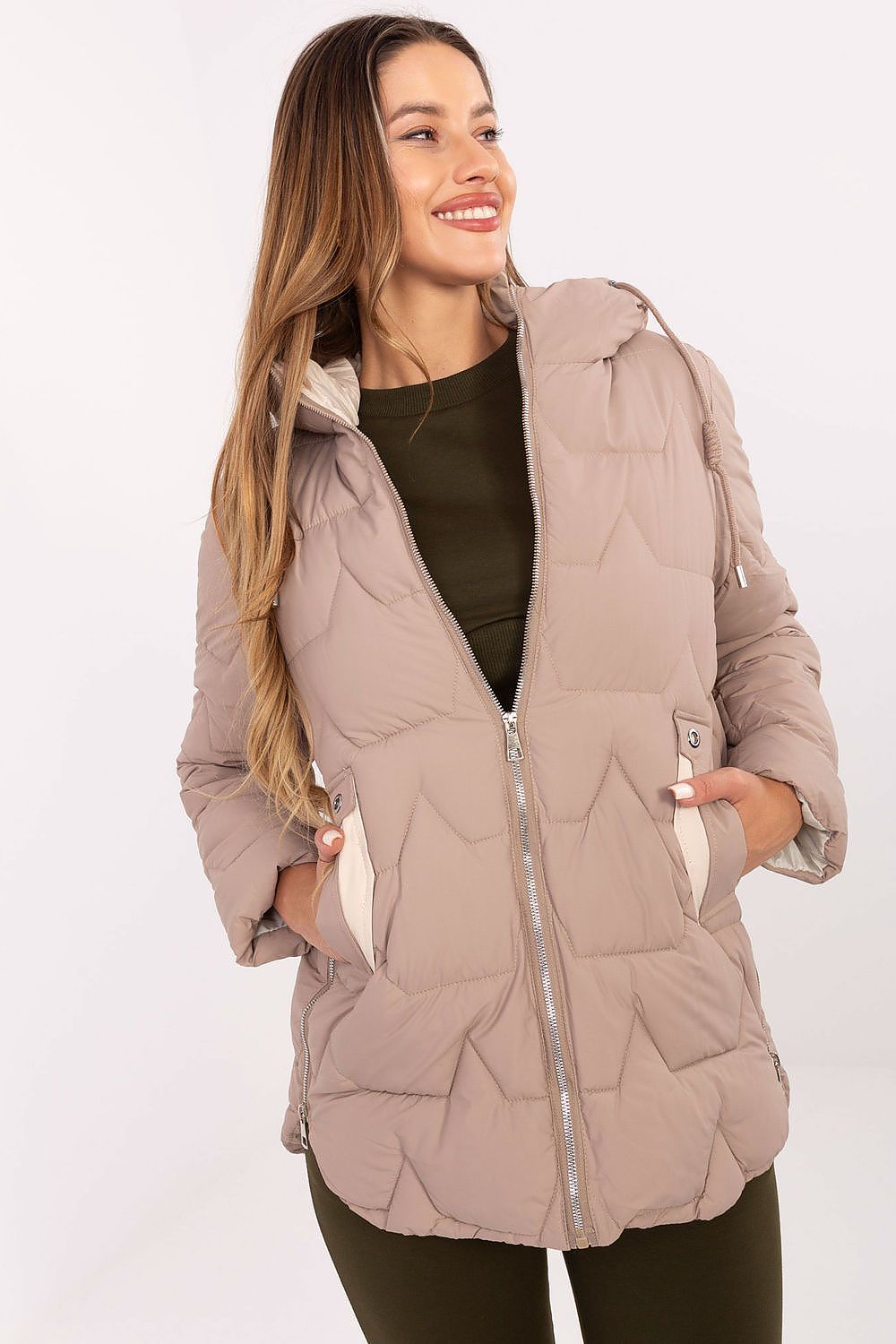 Woman wearing a quilted jacket on a white background