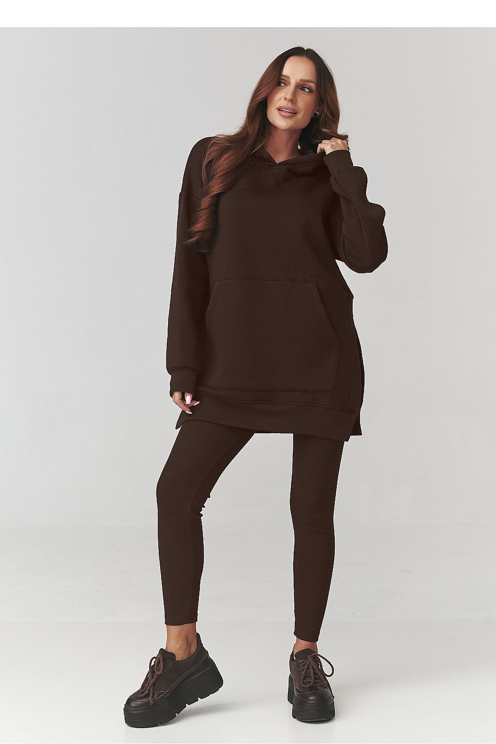 Woman wearing a brown outfit on a white background