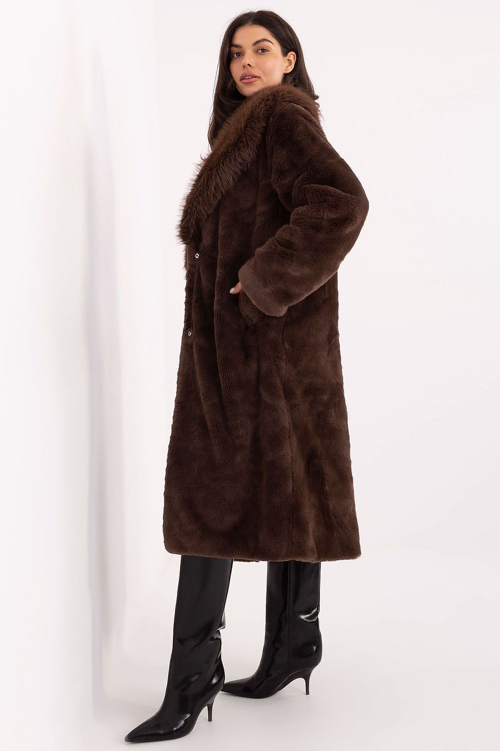 Woman wearing a brown fur coat on a white background