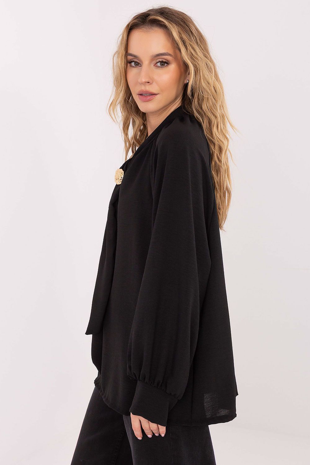 Woman wearing a black outfit with a white background