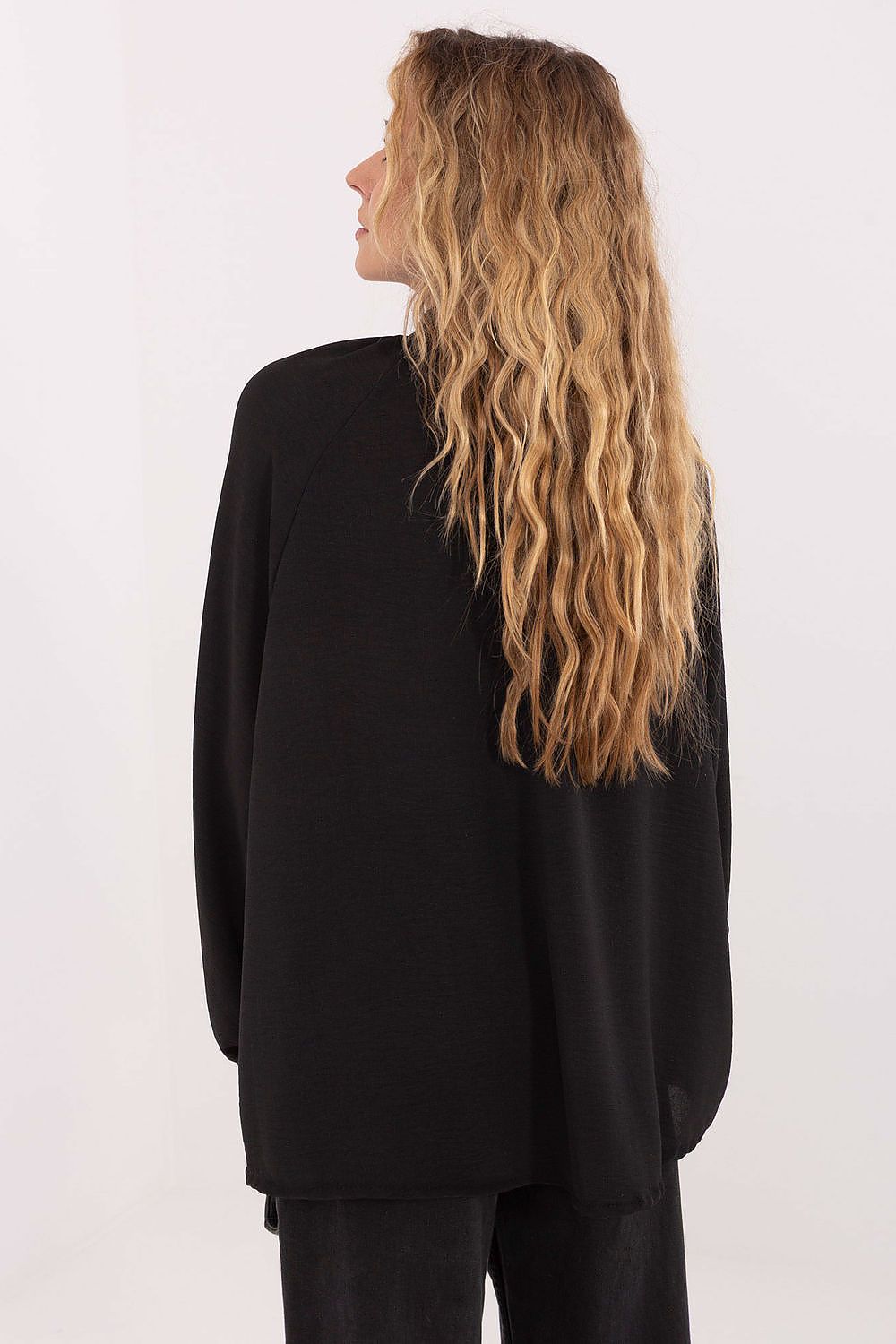 Person wearing a black outfit with long hair on a white background