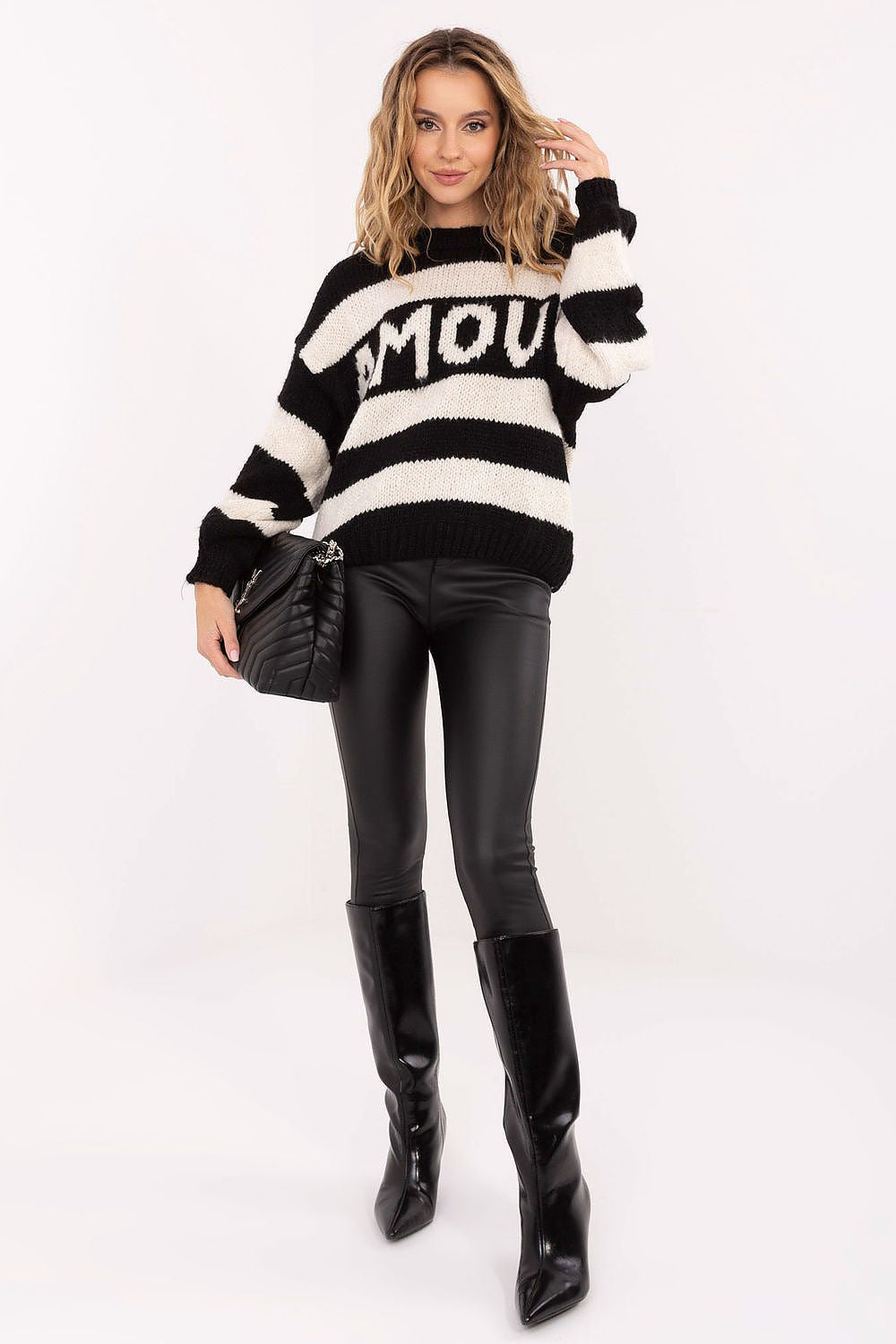  Front view of oversized striped women’s sweater with inscription.