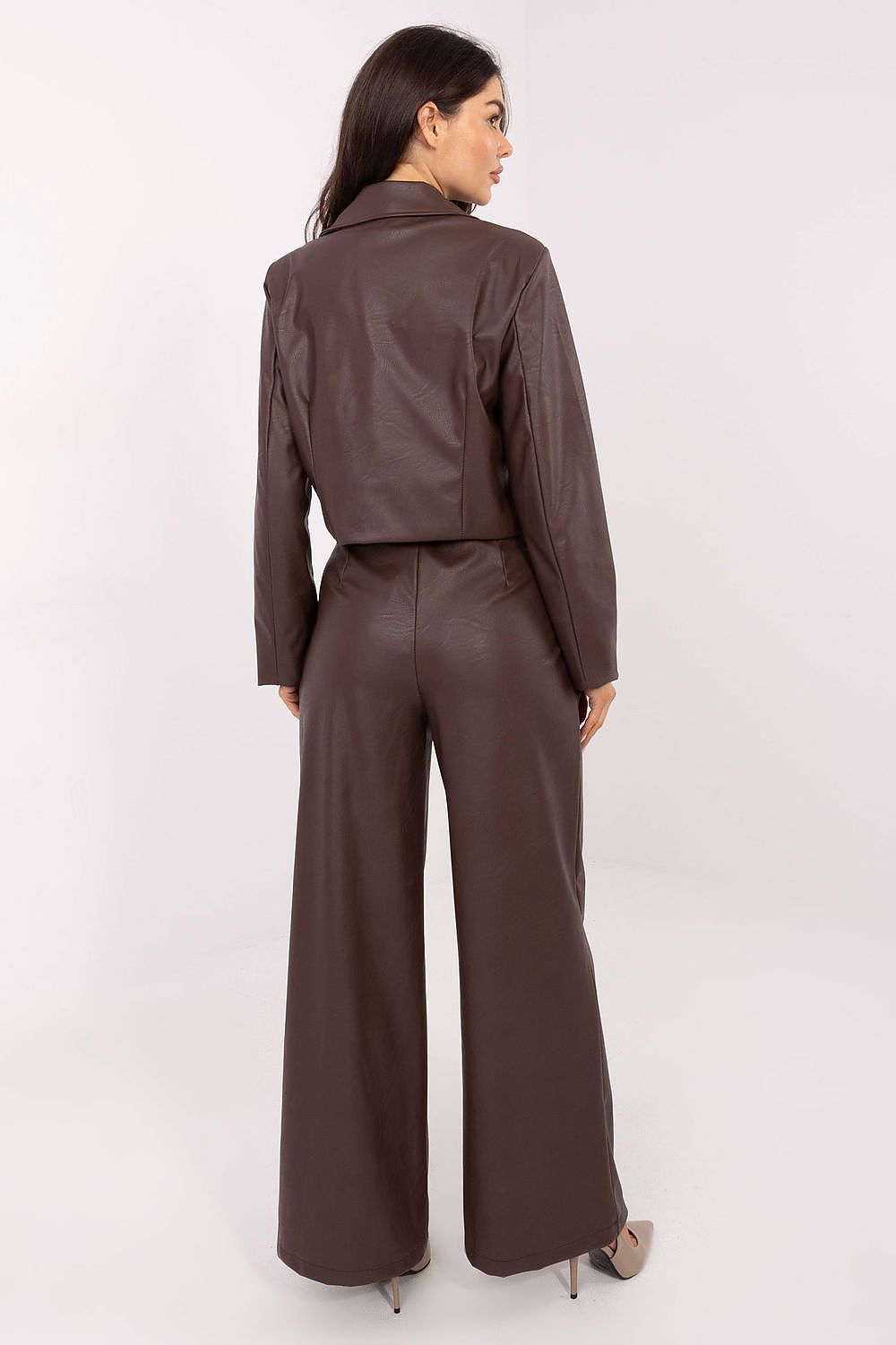 Woman wearing a brown suit on a white background