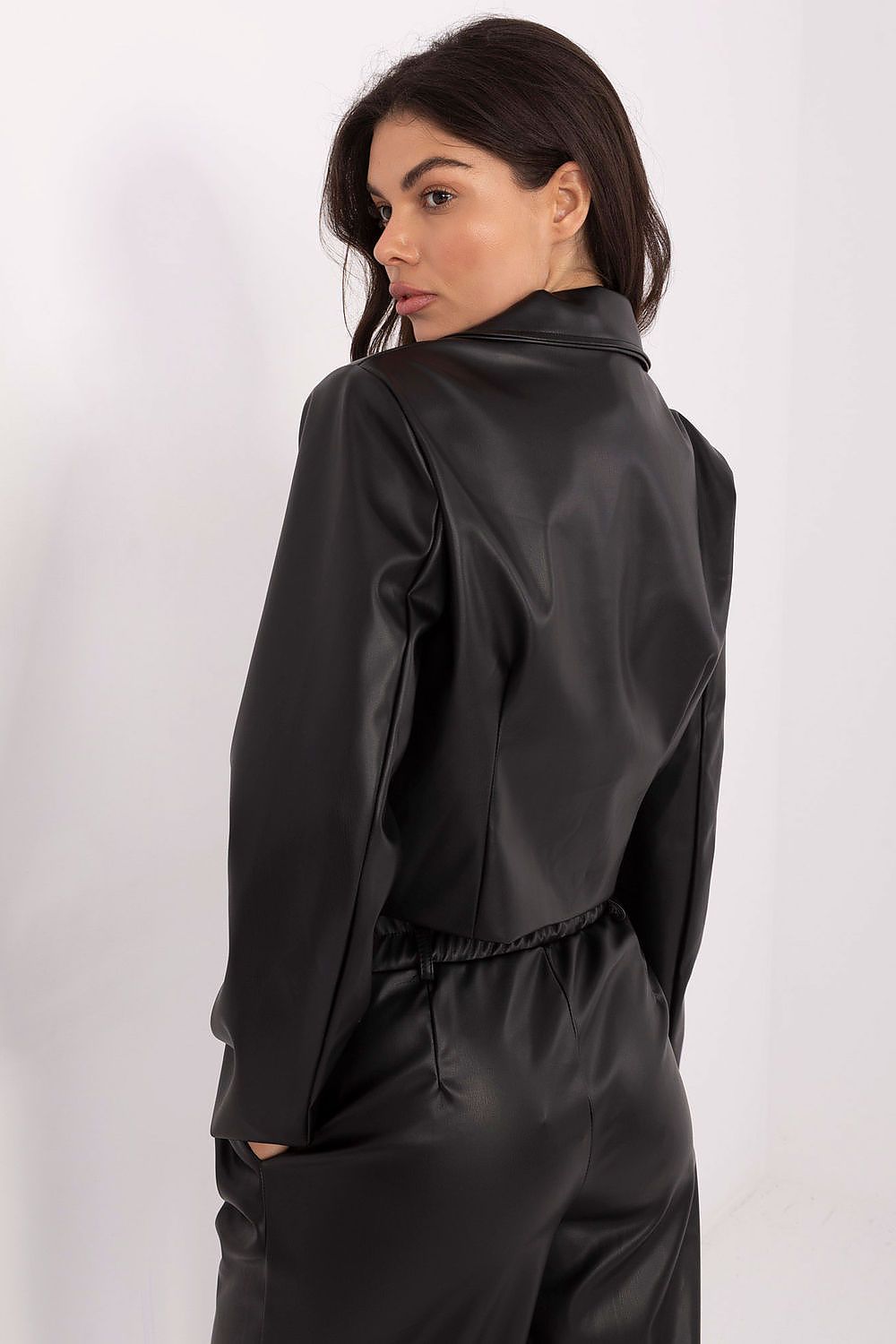 Woman wearing a black satin outfit on a white background