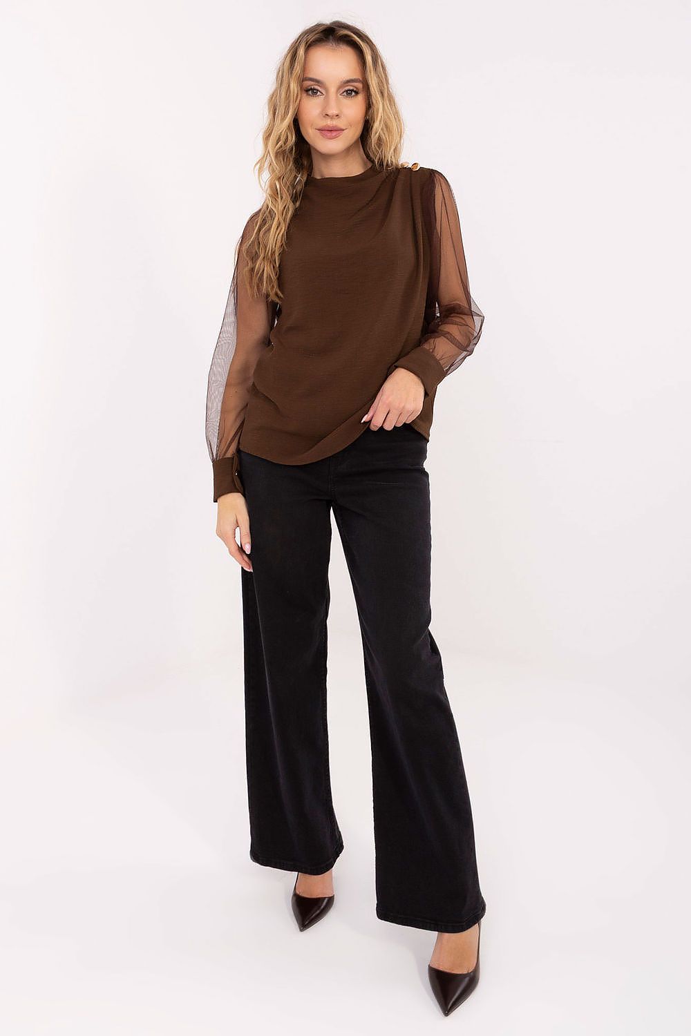  Model wearing brown mesh-sleeve blouse styled with trousers for a chic formal look