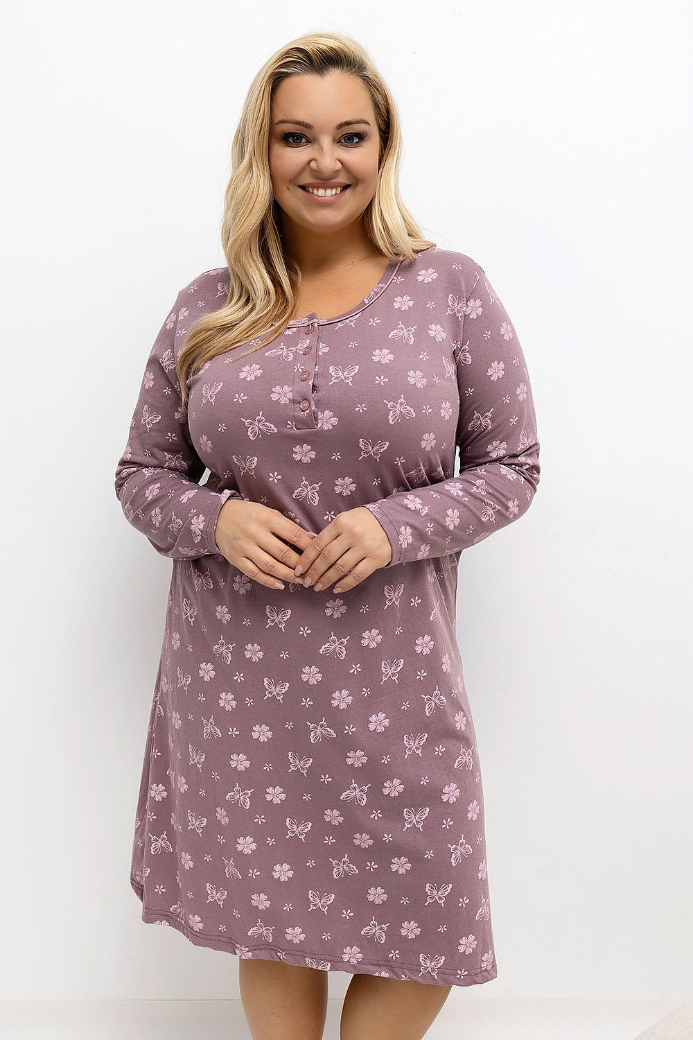 Woman wearing a purple patterned nightshirt on a white background