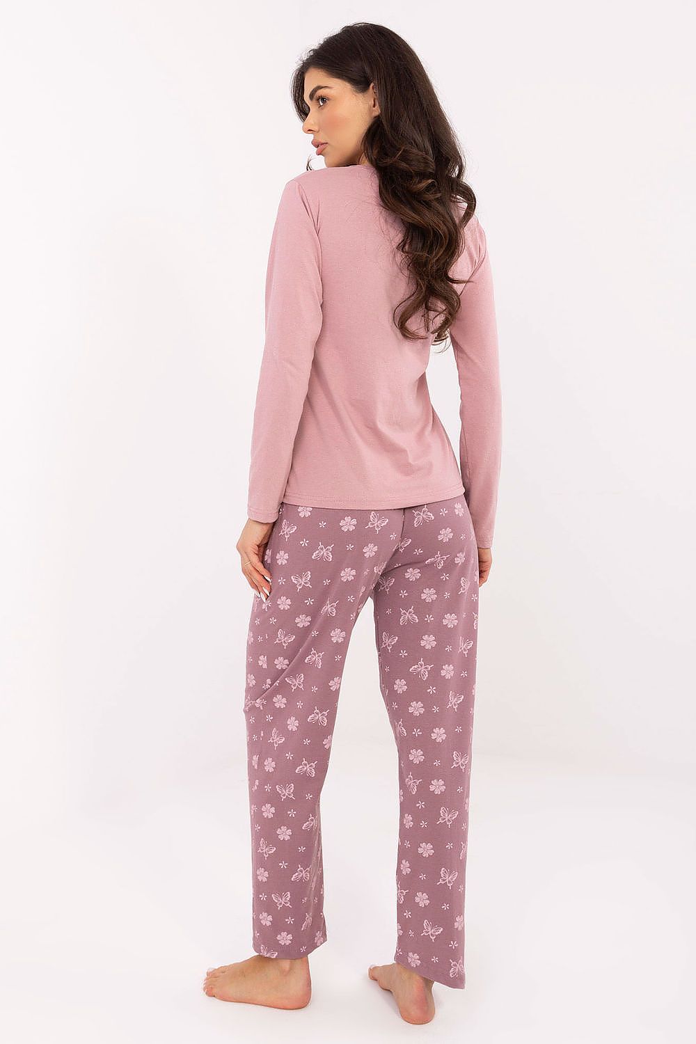  Model wearing pink butterfly print pyjamas, cozy and feminine look
