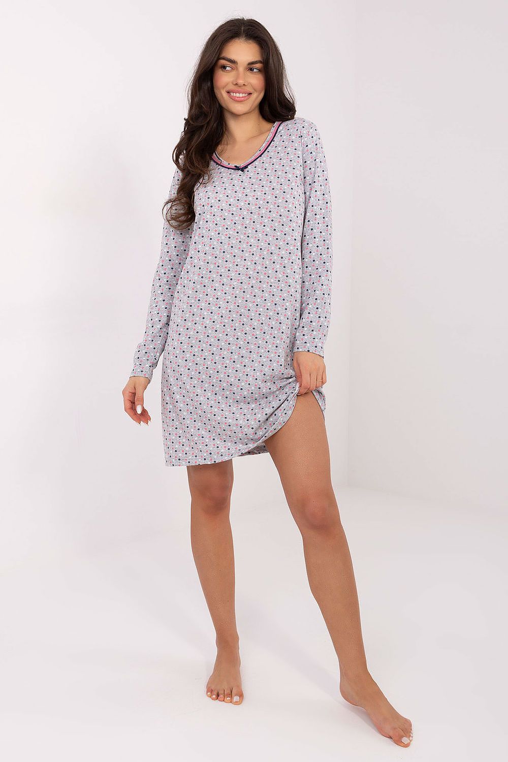 Woman wearing a patterned nightshirt on a white background