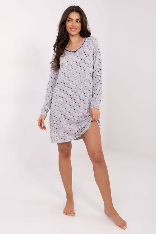Woman wearing a patterned nightshirt on a white background