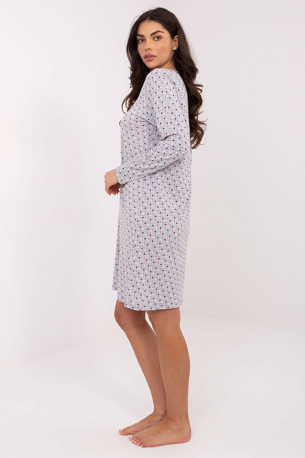 Woman wearing a patterned nightshirt on a white background