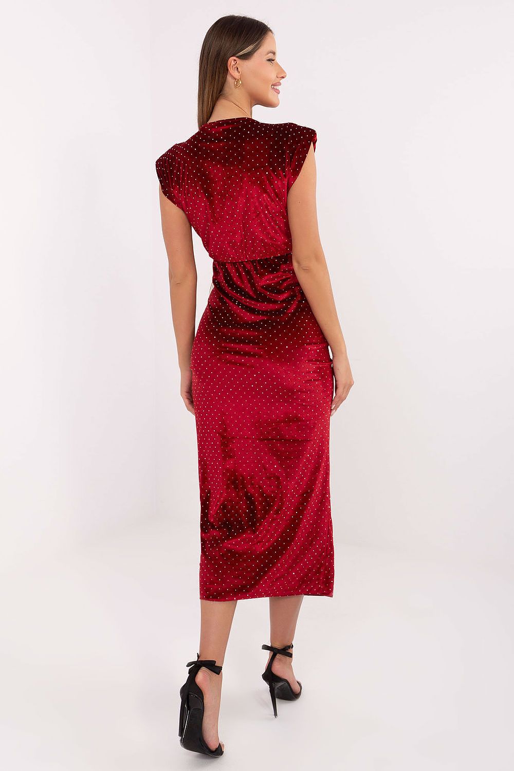 Red patterned dress worn by a model on a white background