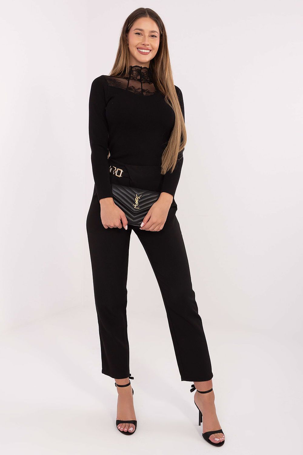 Woman wearing a black outfit with a white background