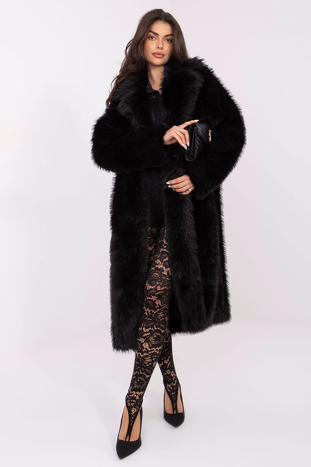 Woman wearing a black fur coat and black lace outfit on a white background