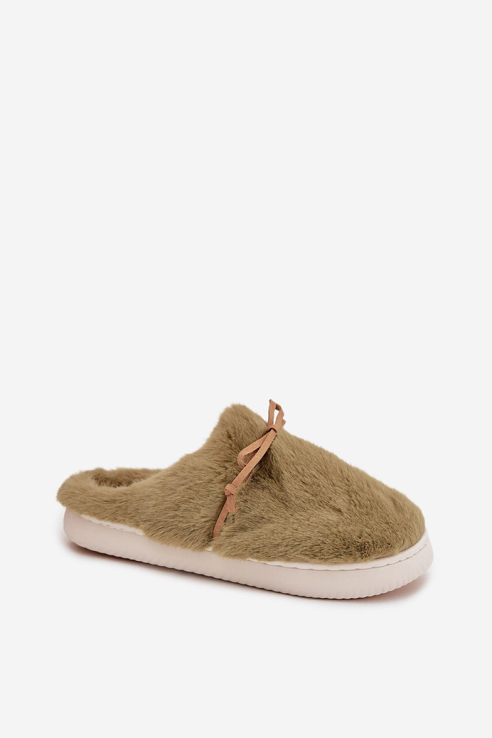 Green fuzzy slipper with a white sole on a light beige background
