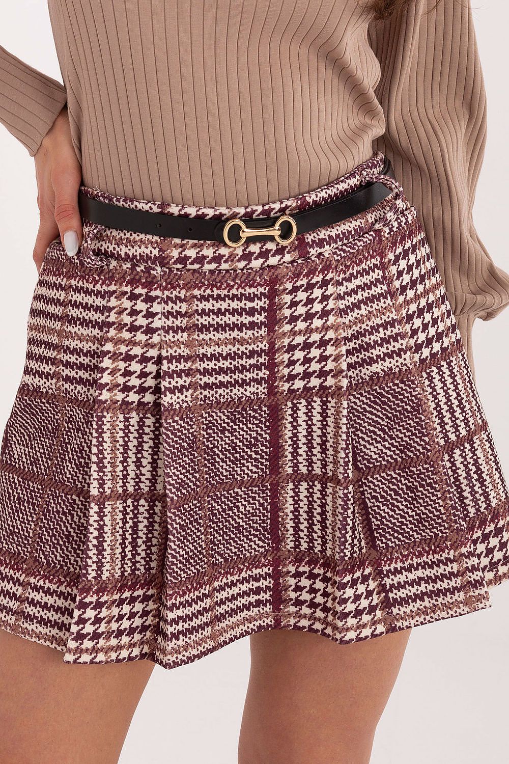 Plaid skirt with a belt worn by a person on a white background