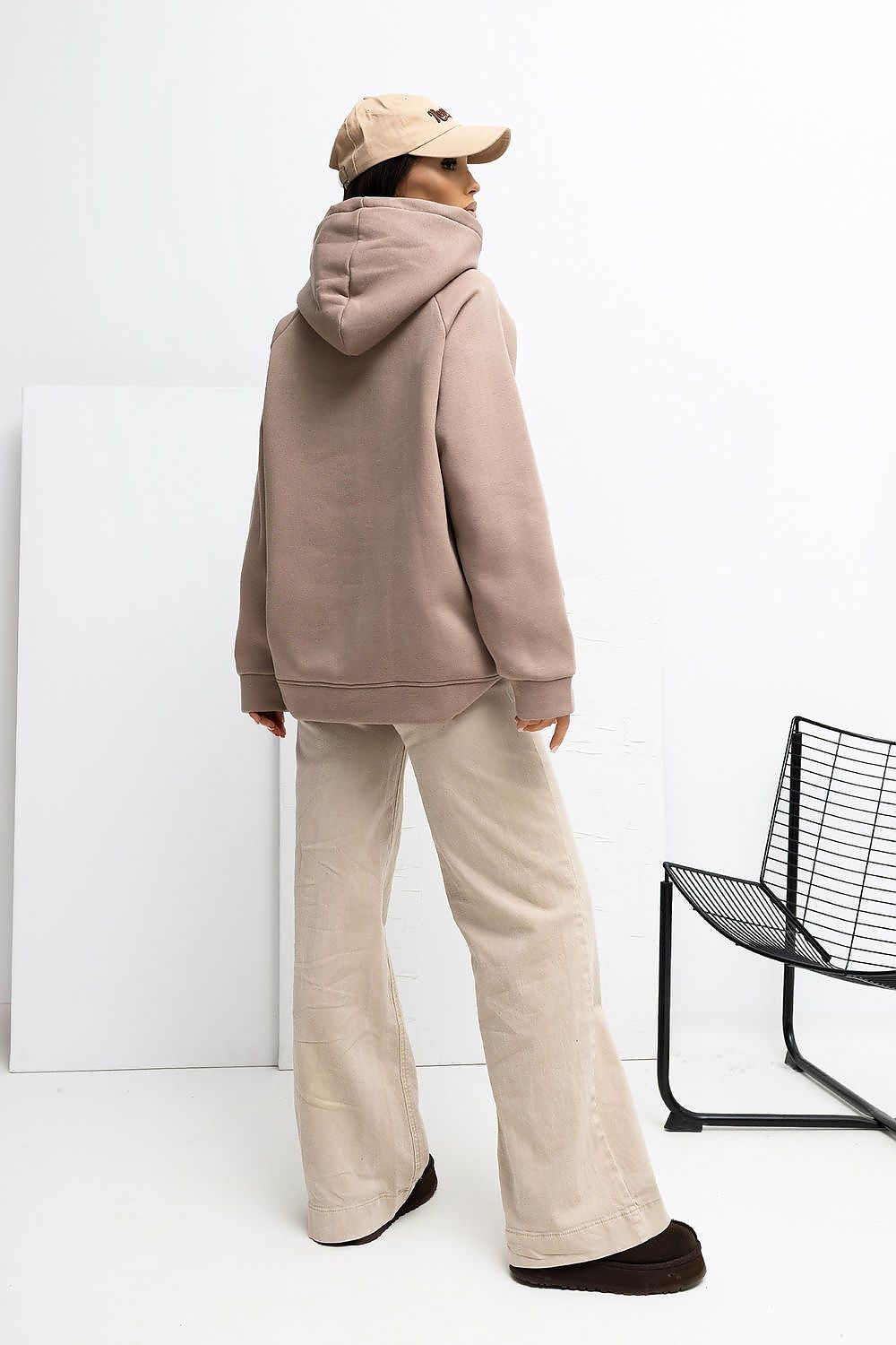  Back view of beige casual sweatshirt showing hood and relaxed fit.