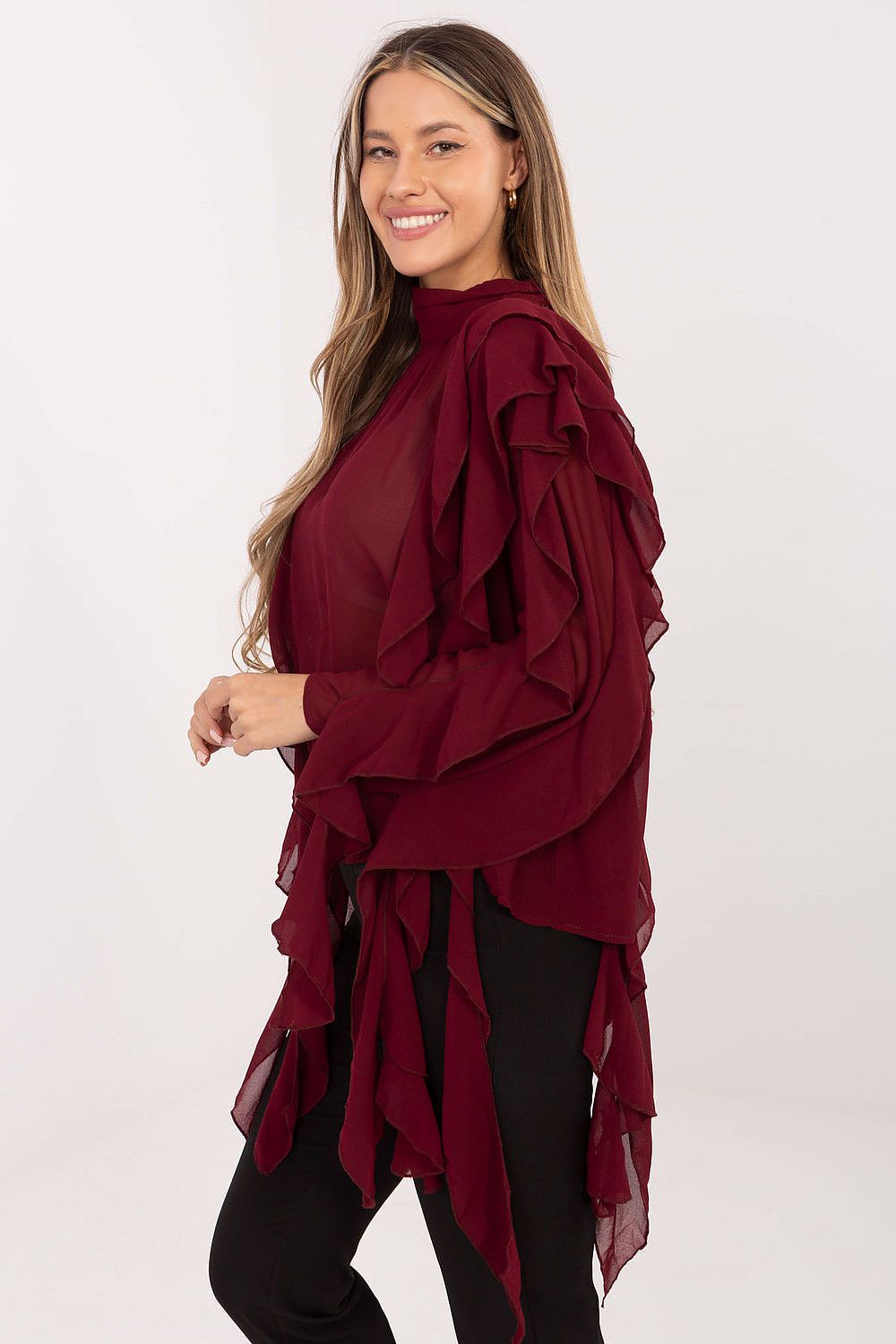 Woman wearing a burgundy ruffled top on a white background