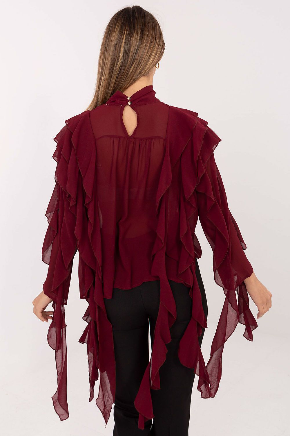 Red ruffled blouse worn by a person on a white background