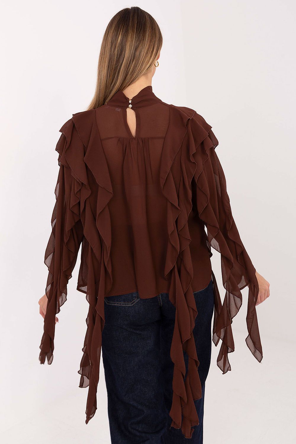 Brown ruffled blouse worn by a person on a white background