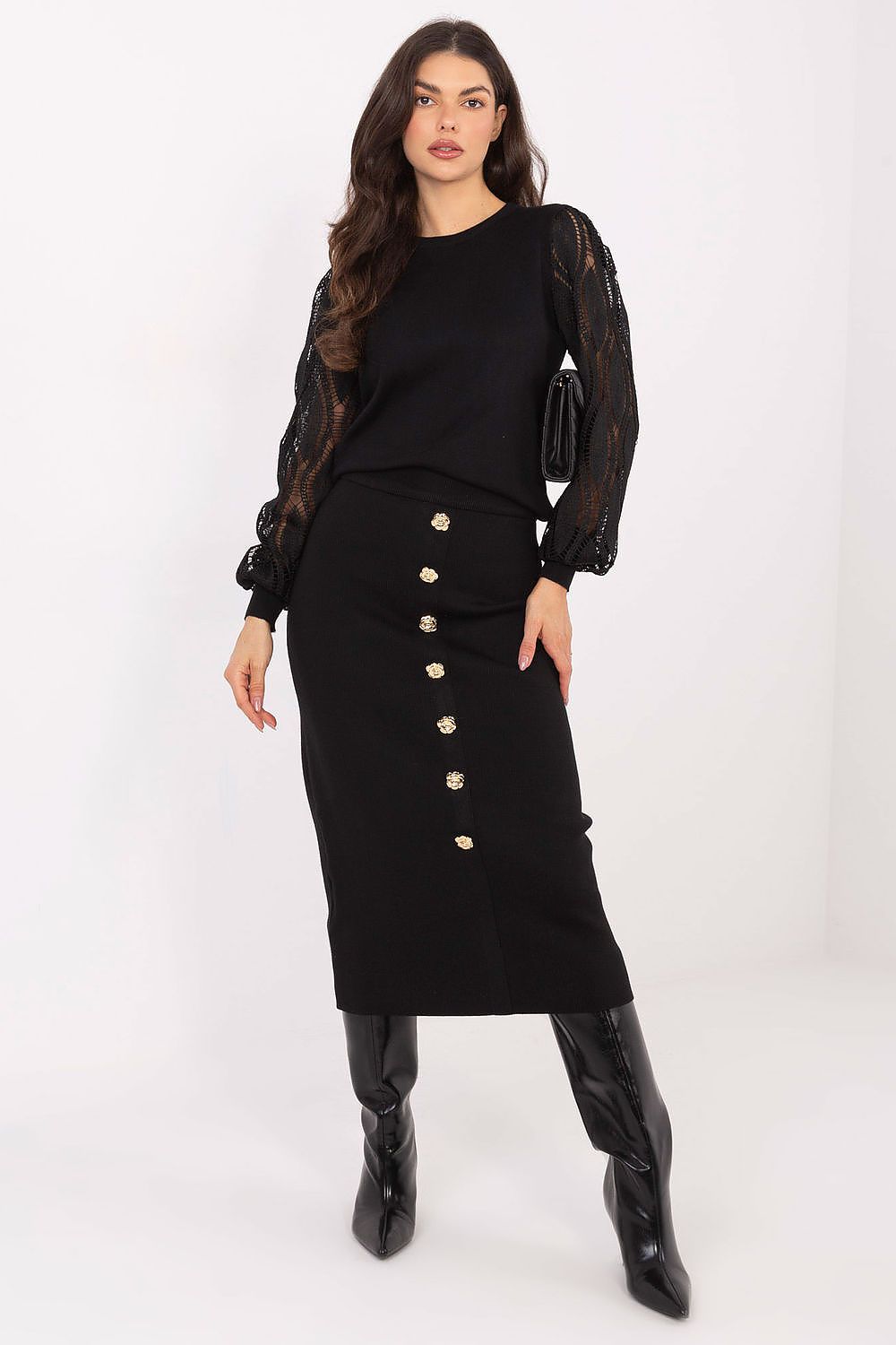 Woman wearing a black outfit with a buttoned skirt on a white background