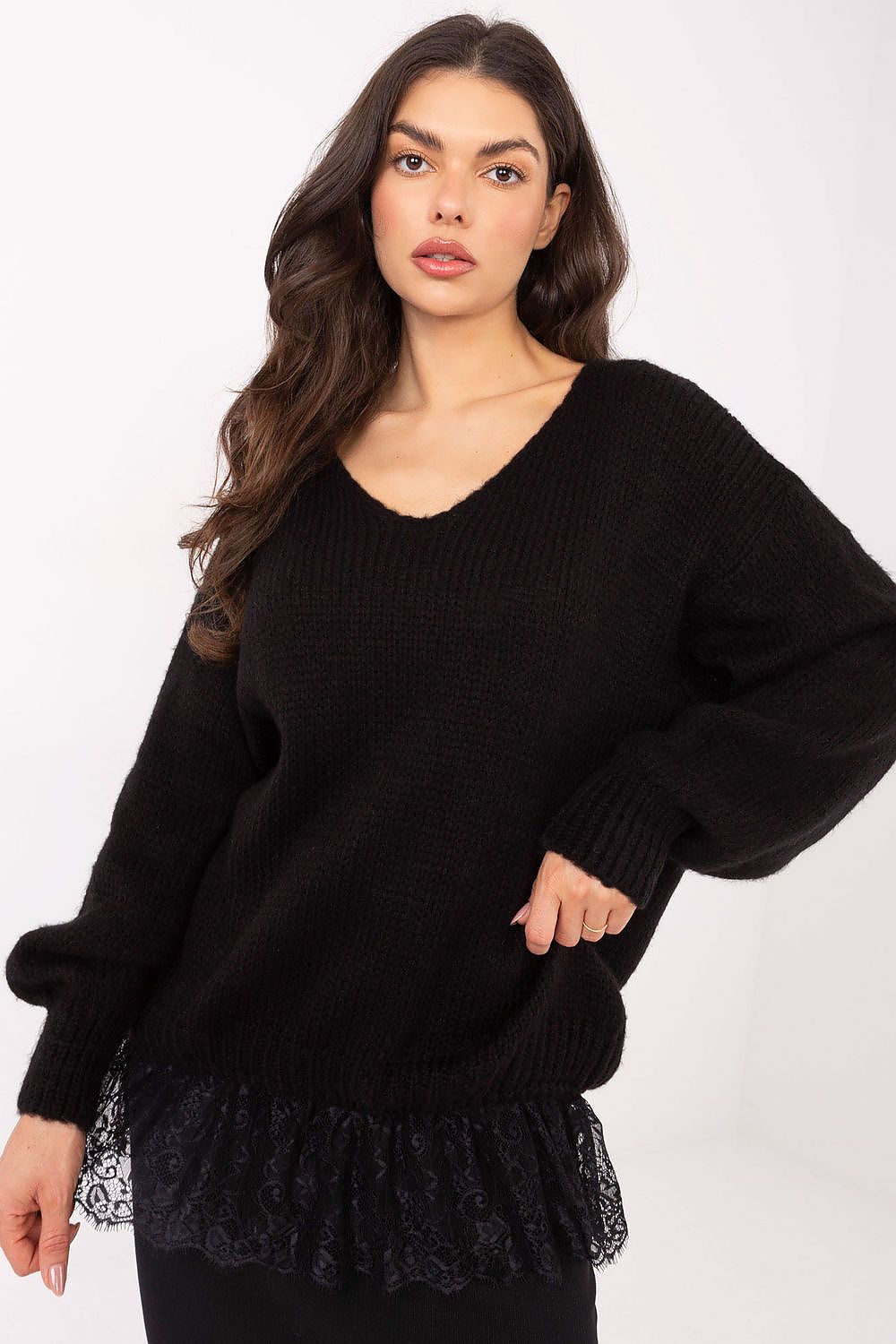 Woman wearing a black sweater with lace trim on a white background