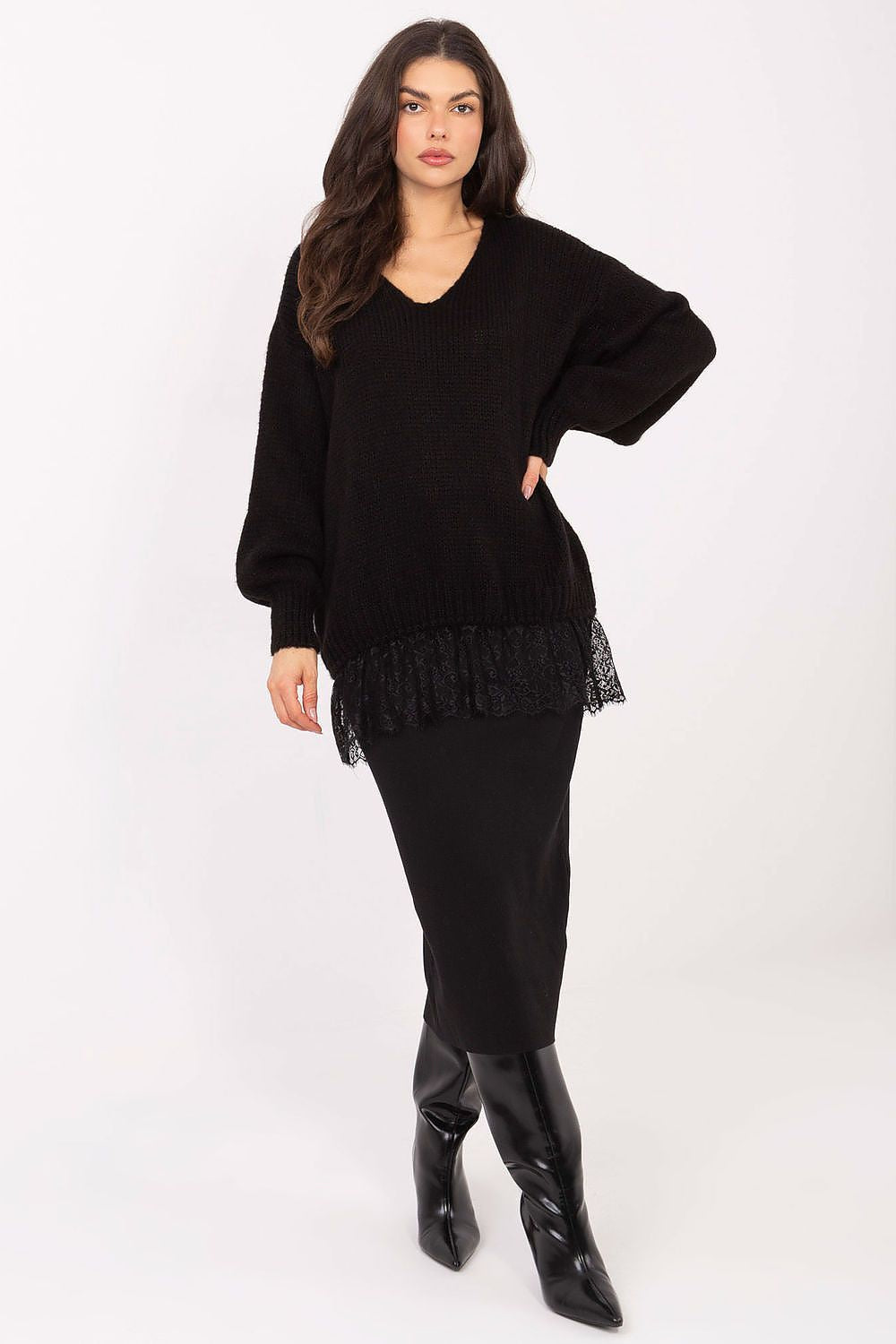 Woman wearing a black outfit with a frilled hem on a white background