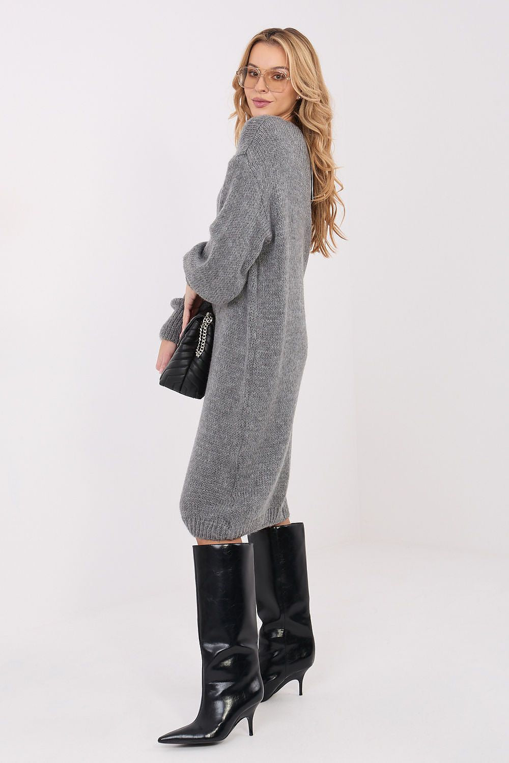 Grey loose-fit knit sweater dress showing drape and side profile. 
