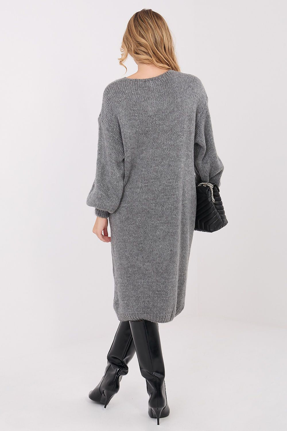 Woman wearing a long gray cardigan on a white background