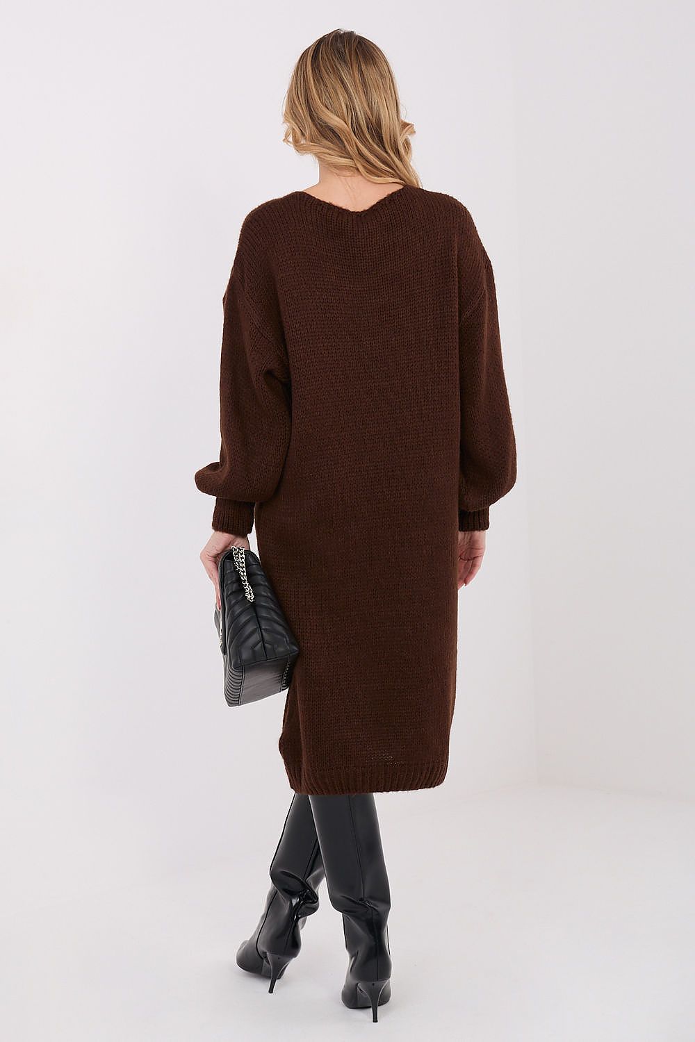 Woman wearing a brown sweater dress on a white background