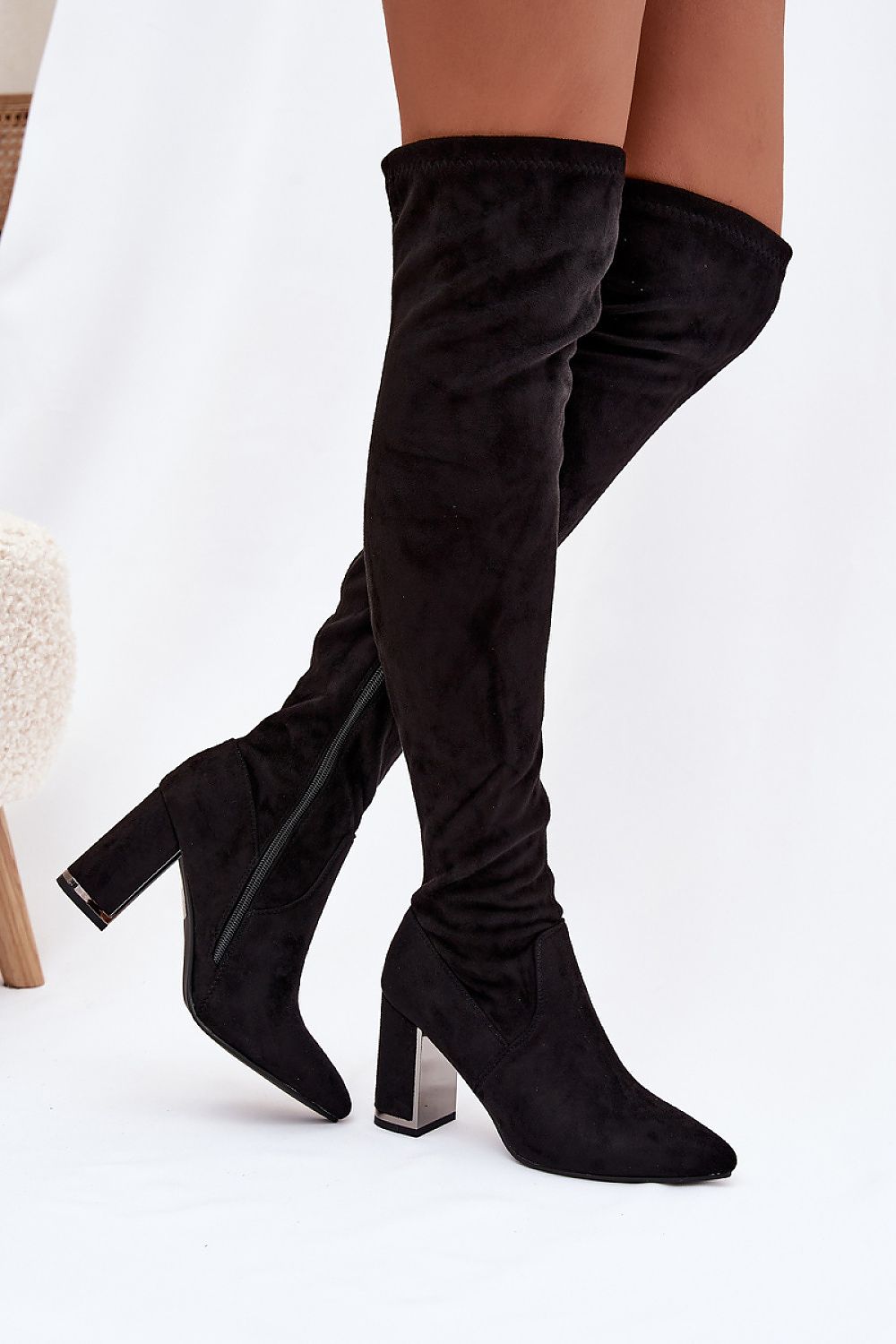 Black over-the-knee boots on a white background
