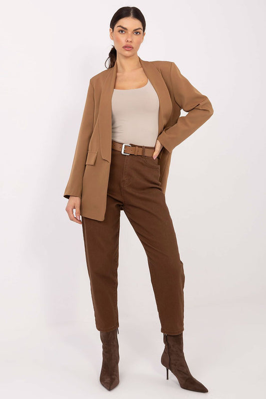Woman wearing a brown suit with a white top on a white background