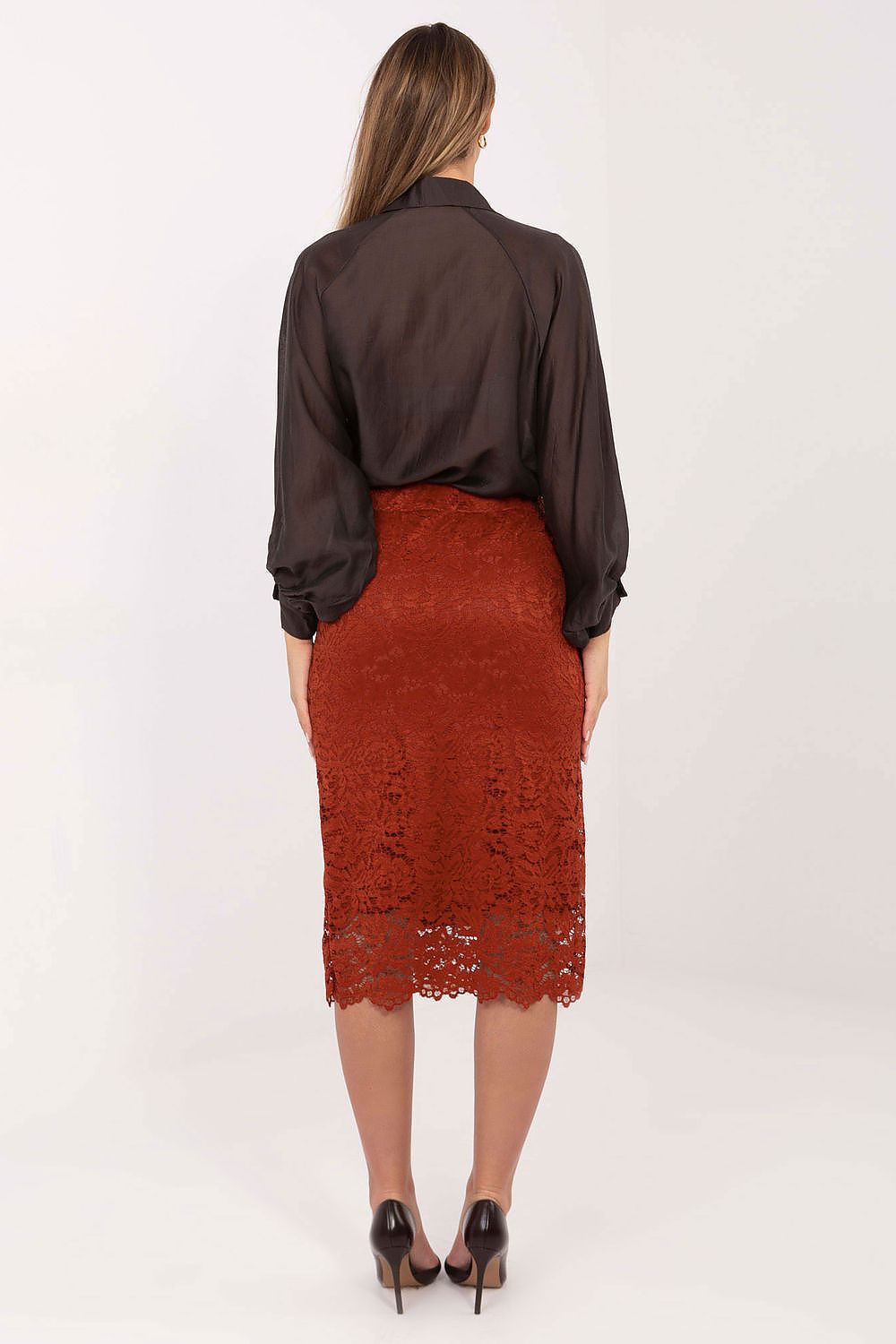 Person wearing a brown lace skirt and dark blouse on a white background
