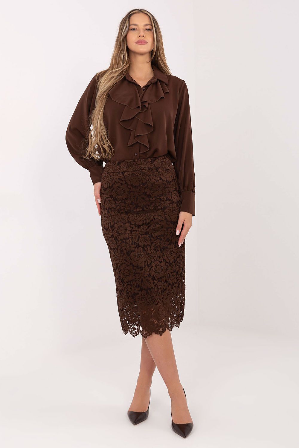 Woman wearing a brown blouse and lace skirt on a white background