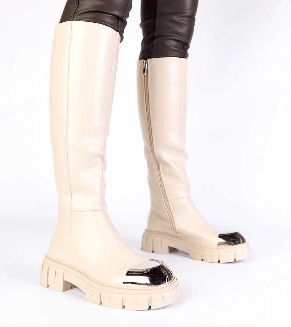 White knee-high boots with a slight platform on a white background