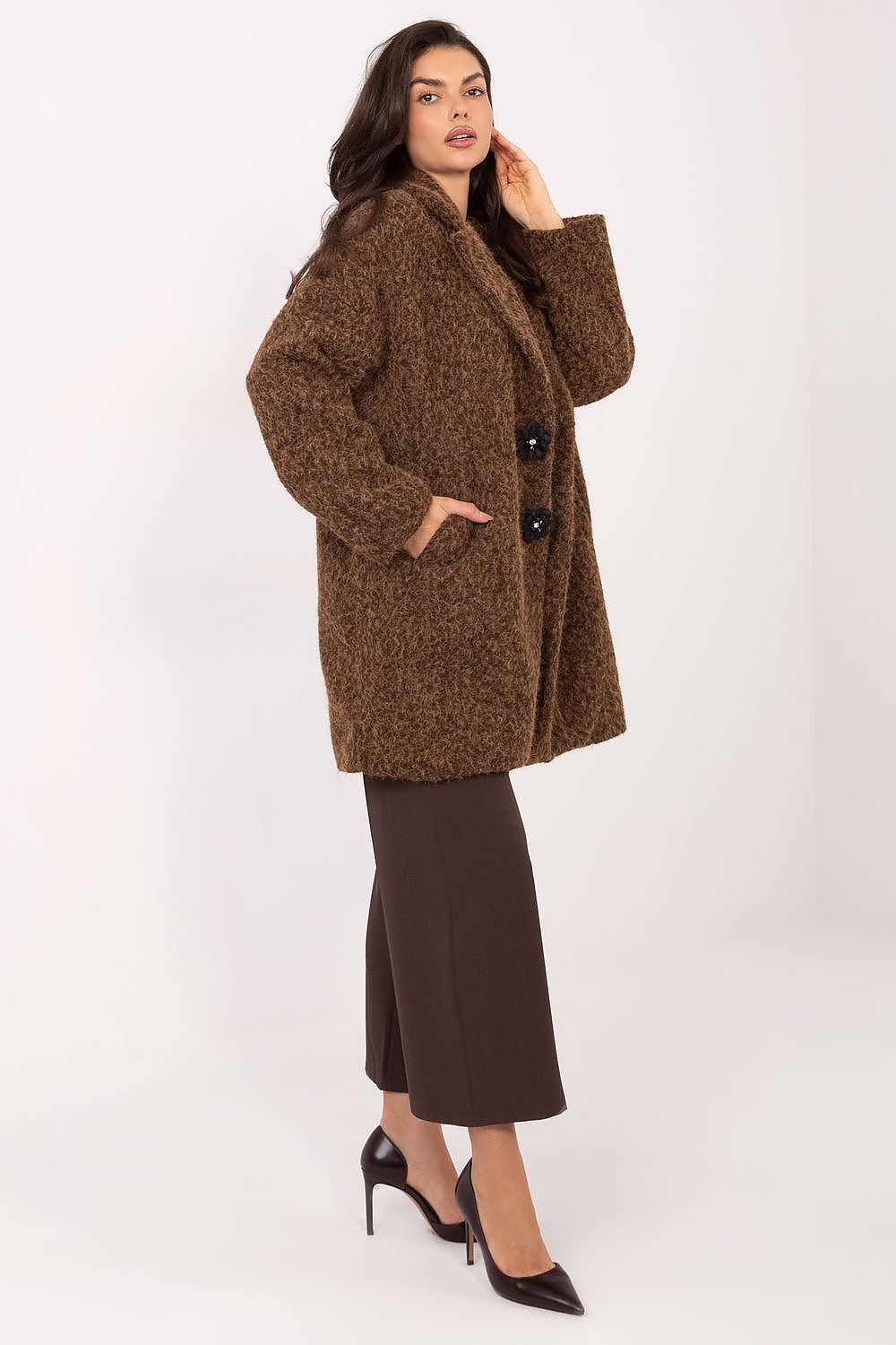 Woman wearing a brown coat on a white background