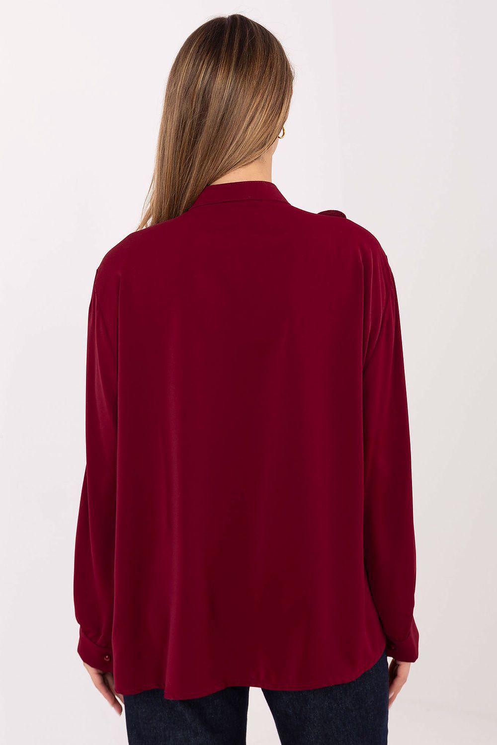 Maroon long-sleeve top worn by a person on a white background