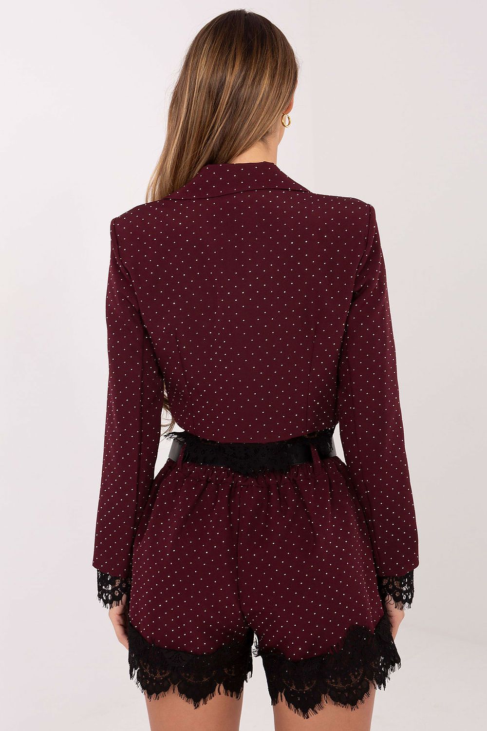 Maroon polka dot dress with lace trim on a plain background