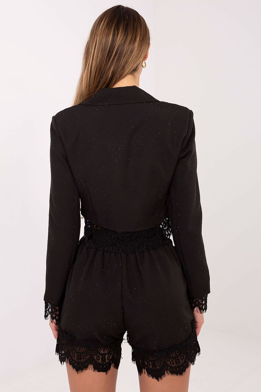 Black romper with lace details on a white background