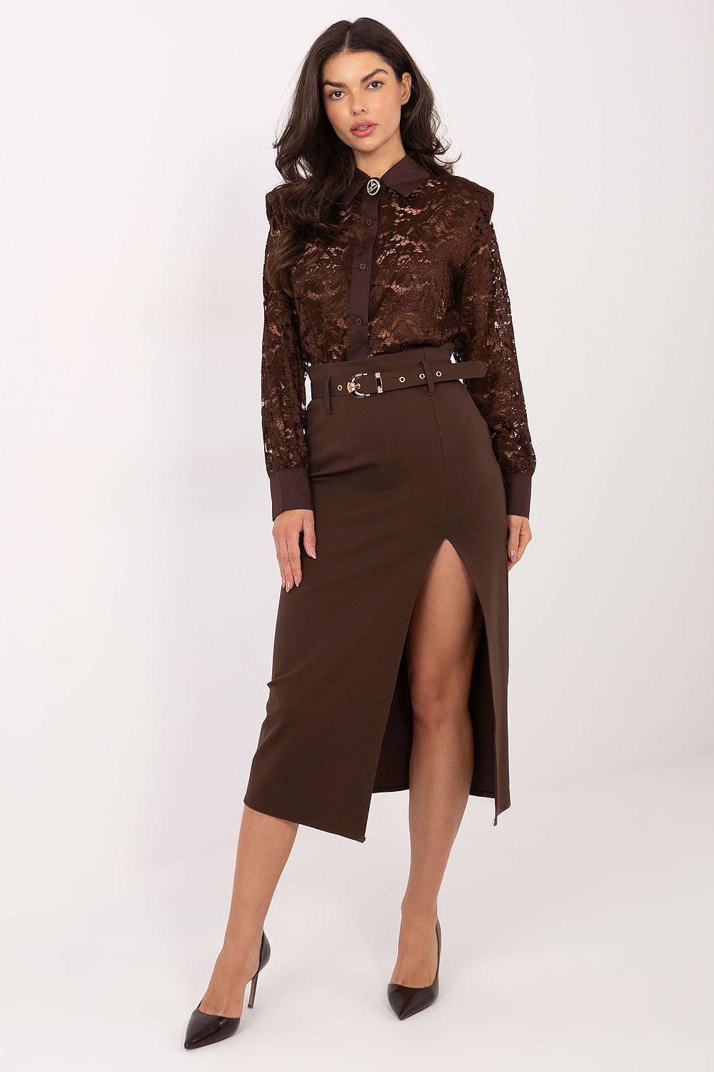 Woman wearing a brown lace blouse and skirt with a belt on a white background