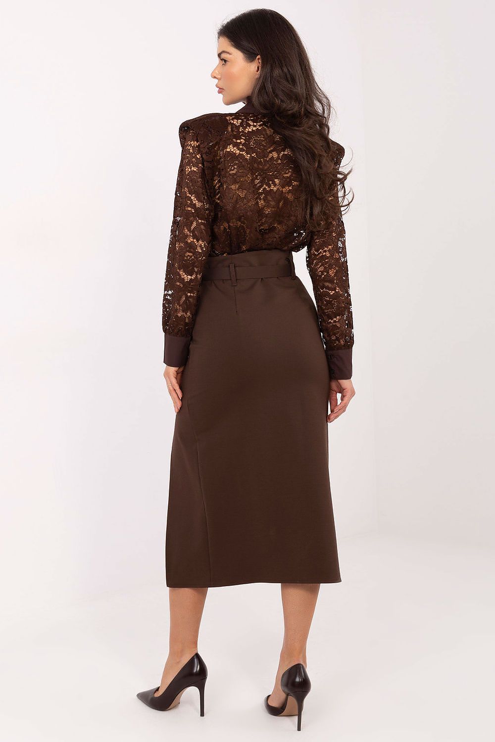 Woman wearing a brown lace top and skirt on a white background