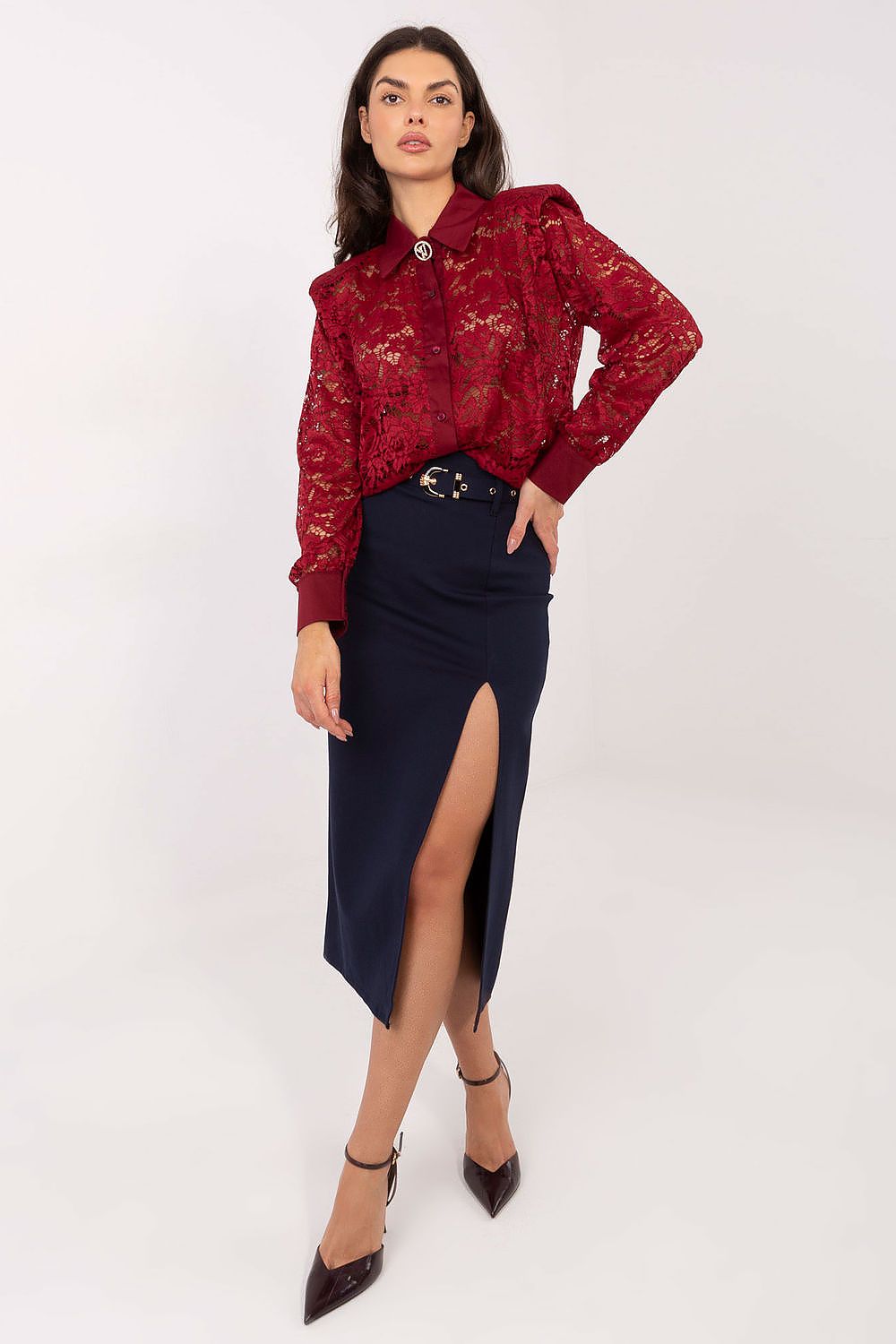 Woman wearing a red lace blouse and black skirt on a white background