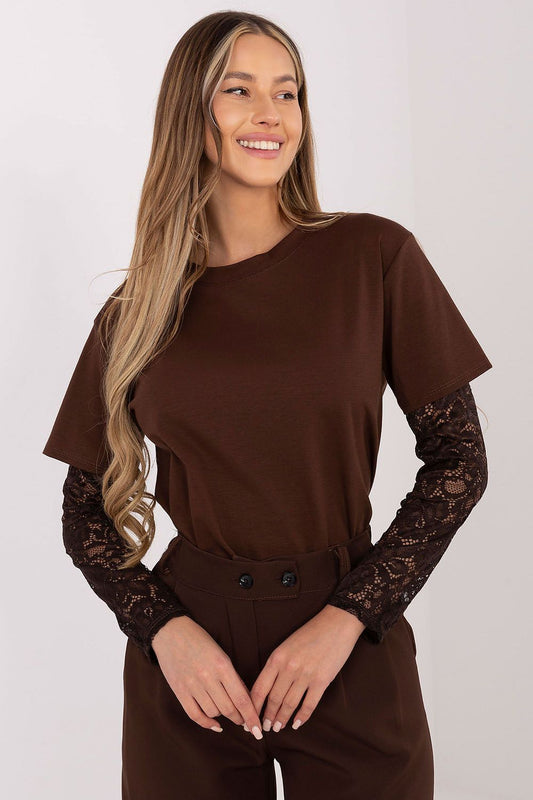 Woman wearing a brown top with lace sleeves on a white background