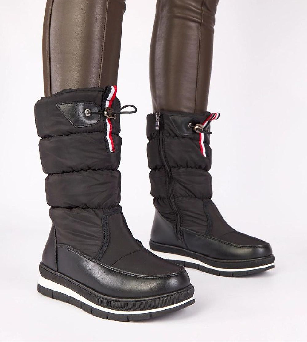 Black winter boots with white soles on a white background