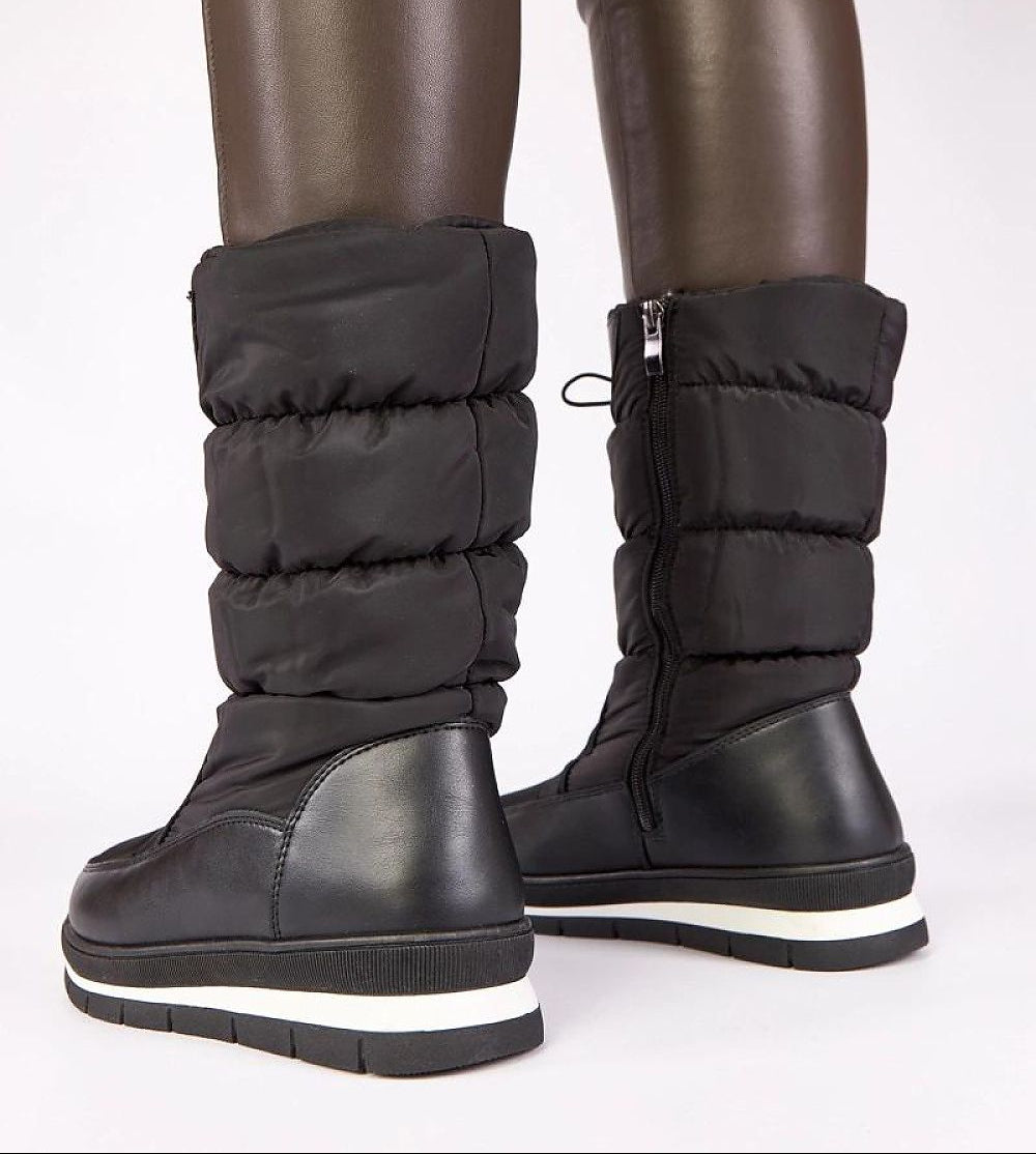 Black winter boots with white soles on a white background